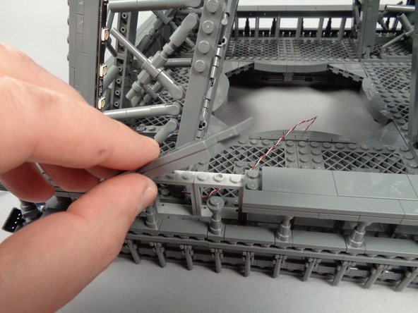 Make sure the wire passes UNDER the "X" shaped frame at the base of the pillar, and BEHIND the window frames.