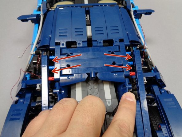 As shown in the second photo, disconnect the left and right Technic beams holding the rear roof.