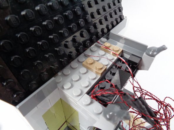 The second photo for this step shows the new position for the 1x2 plate.