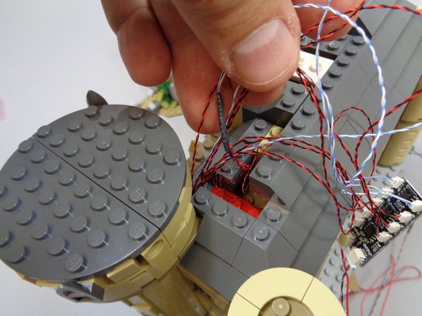 As shown in the second photo, make sure all wires are behind the larger top section and that no wires are caught underneath.