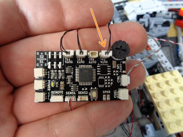 As shown in the photos for this step, connect the landing lights to the OUT4 connector on your TRUNK08 master controller.