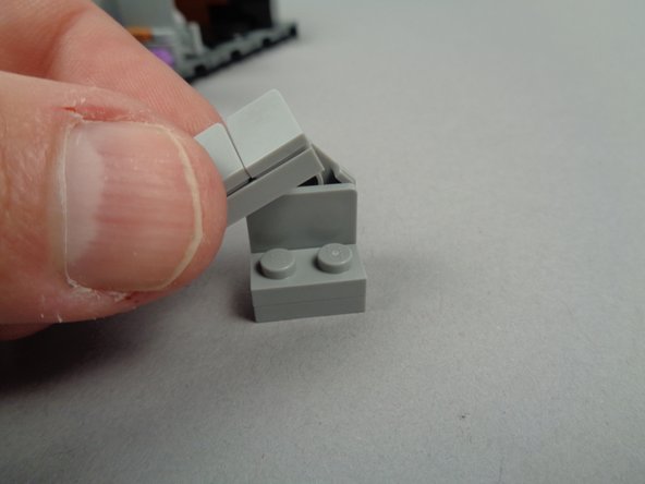 As shown in the photos for this step, remove the WITCH HAZEL tombstone and remove the tile and slopes on the back side of the tombstone.