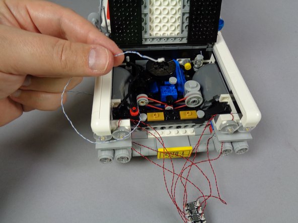 As shown in the first photo for this step, find the blue/white wire coming from the speedometer light that you installed earlier.
