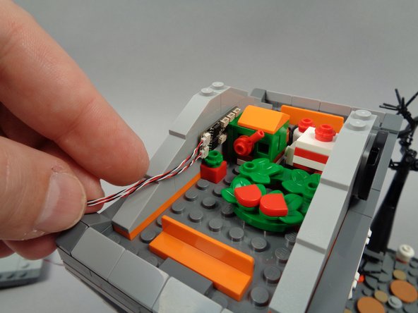 As shown in the first photo for this step, test-mount the BRANCH06X driver board in the center rear of the attic of the town hall.