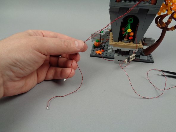 As shown in the first photo for this step, you will have two light wires remaining.  One of them will be longer than the other.  The longer wire is the attic light wire.