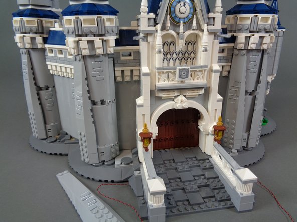 As shown in the first two photos for this step, remove the large slope from the left front tower next to the door.