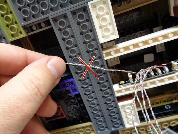 Now you can attach the five spotlights to the castle base.  It's up to you where to mount them-- in general the lights should be evenly spaced along the front and side edge of the castle base, shining up on the castle.