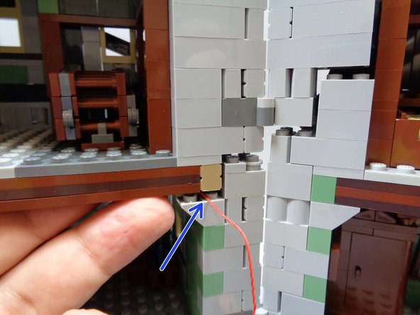 As shown in the first photo, use a brick separator to raise the second floor so you can run the red control wire connected to the BRANCH09X adapter  on top of the light bluish gray floor support.