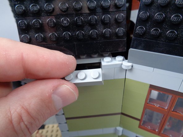 As shown in the photos for this step, remove a third piece to make room to pass the green LED light wire: