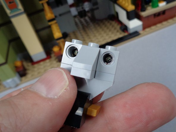 The first photo for this step shows the front of the Pharaoh's face.  You can see the two tiny LED lights inside, facing forward.