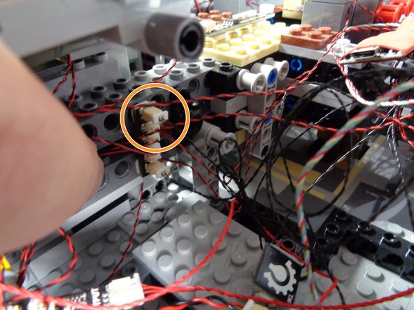 As shown by the orange circle in the second photo, connect one end of that spare black wire to the open plug on the BRANCH15 adapter-- this is the same adapter you just disconnected the short black wire from earlier.