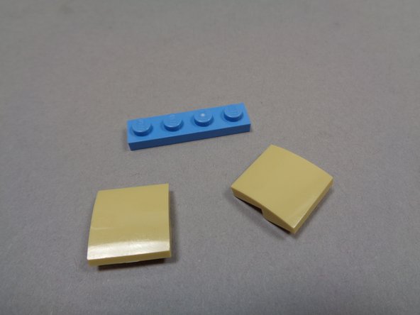 As shown in the second photo, remove the tan slopes running up the rear of the tower.