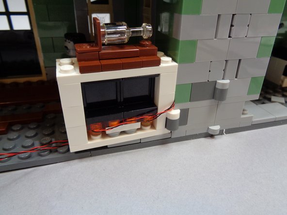 Move the fireplace back and forth to make sure it can still move with the lights mounted inside.