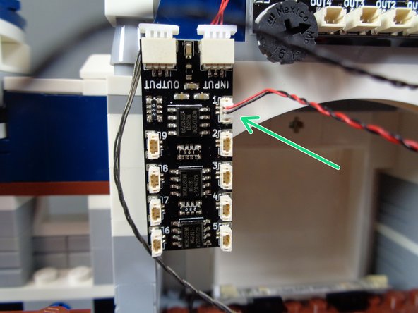 Attach the BRANCH09X adapter board to the back castle wall with the large sticky square.