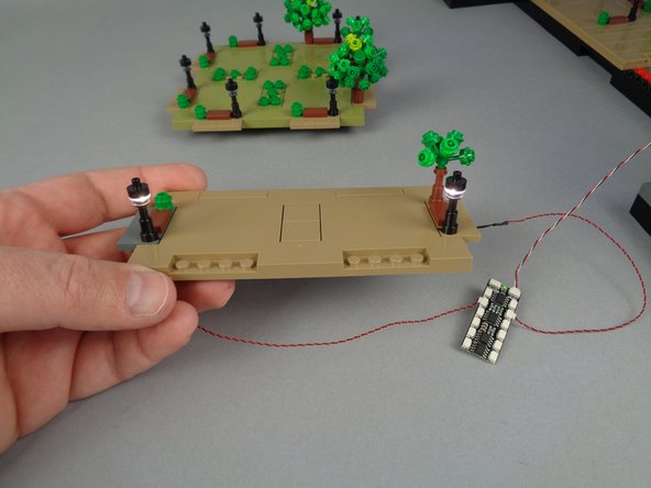 As shown in the second photo, connect the two lamp posts to any two plugs on the BRANCH12X driver board to make sure they both turn on.
