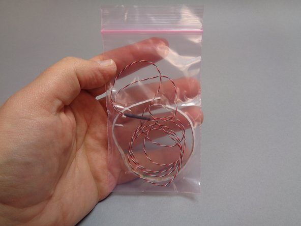 Remove the flexible LED light strip from its pink bag.