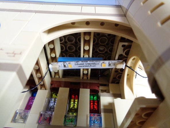 The light strips have a self-adhesive backing.  Once you have placed several of the light blue plates on the ceiling, you can stick the light strips to the light blue plates.