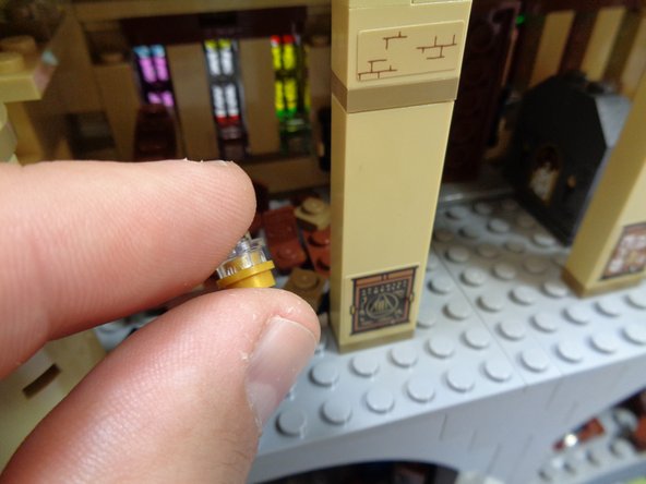 You will now mount a warm white light inside the small lamp in the library.