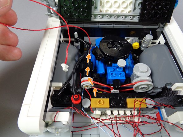 As shown in the second photo, position the BRANCH09X adapter board in the center of the Ecto-1, with the large plugs facing left, and pressed up against the engine frame.