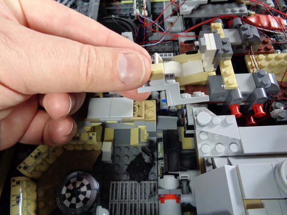 As shown in the second and third photos, carefully remove the pieces holding the computer in place.