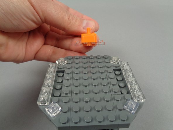 As shown in the photos for this step, remove the six clear 1x2 plates on either side of the top center.