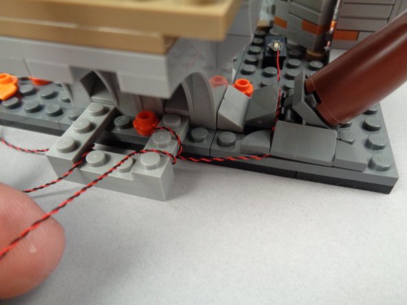 Re-attach the 1x2 slope piece, making sure the LED light wires pass between, not on top of, any studs.
