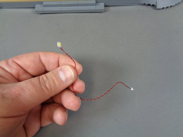 Now you will prepare to mount a warm white Pico LED light behind the exterior clock above the main castle door.