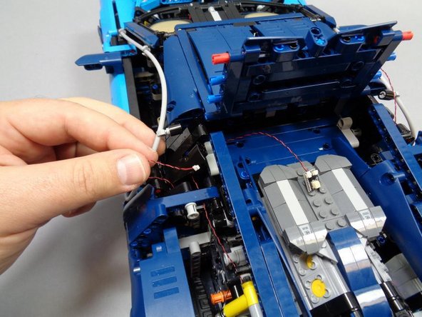 As shown in the first photo, route the wires from the front and rear left turn signals toward the center area under the roof.