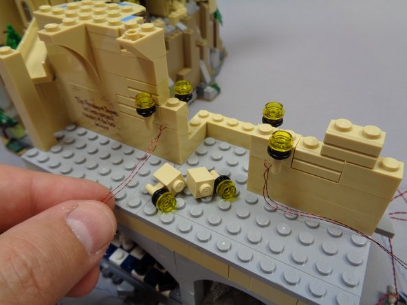 As shown in the first photo, attach the second torch &quot;Y&quot; assembly to the left of the arch opening.