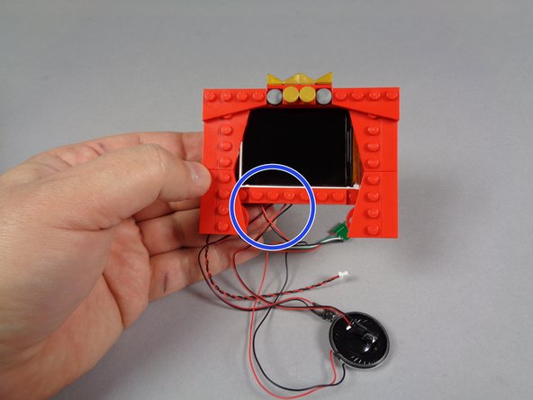 As shown in the first photo for this step, mount the new frame on top of the video player and large white tile.