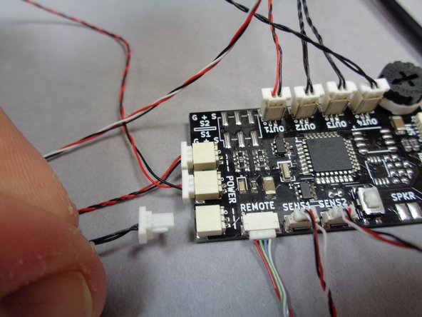 As shown in the first and second photos, connect the other end of the 6&quot; connecting cable coming from the BRANCH18 adapter to the plug on the TRUNK08 master controller where the USB cable originally connected. (see the red circle in the second photo)