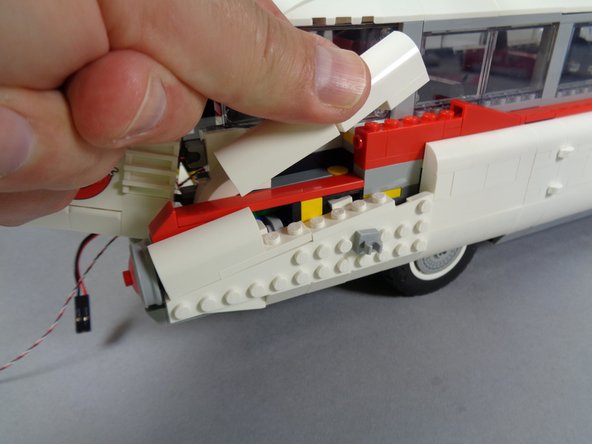 As shown in the second and third photos for this step, remove the other parts of the rear right lower frame.