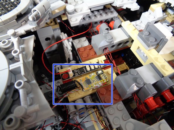 As shown in the third photo, use the sticky square to mount the remote receive on the large tan plate next to the BRANCH09 adapter board.