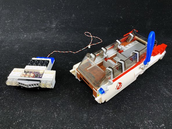 Remove the pre-assembled Brickstuff hood assembly from its anti-static bag, and mount onto the front of the Ecto-1 as shown in the third photo.