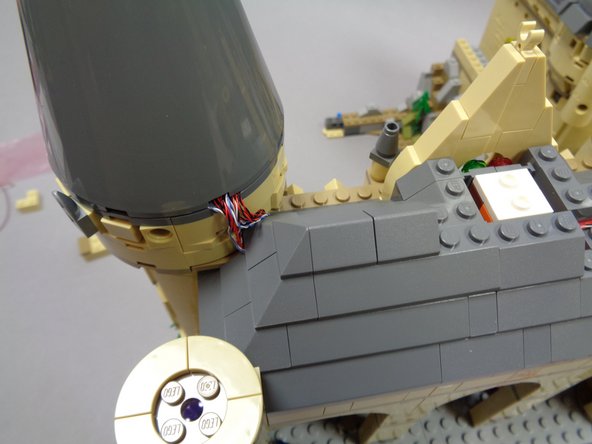 As shown in the third photo, remove the light blue 1x2 brick from beneath the right side of the exposed roof.