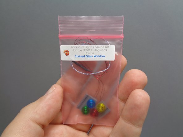 Remove the pre-lit stained glass window bag from inside Bag 10.