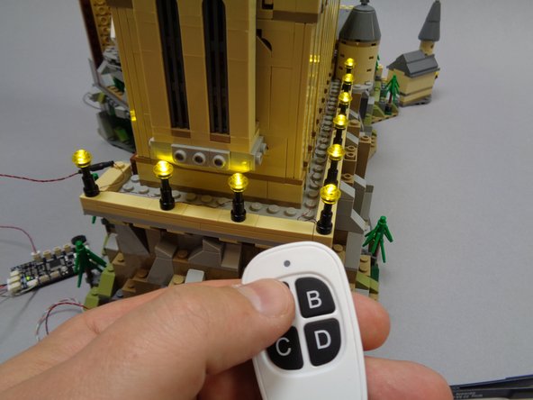 As shown in the third photo, if the lamp post string does not come on when power is connected, you can press and release the &quot;A&quot; button on the remote control quickly (less than 1 second).  This should turn the lamp post string on (a &quot;short press&quot; of the &quot;A&quot; button turns the lamp post string on and off).