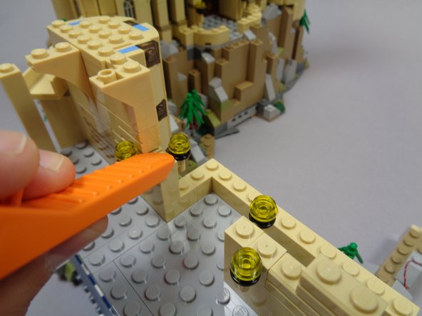 Continue disassembling the wall sections with the four torches as shown in the first and second photo.