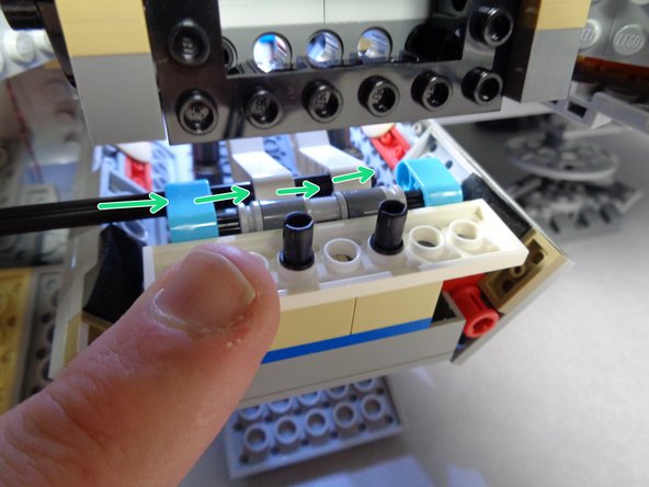 Make sure both arms are in the same position (parallel) when inserting the axle into the second arm.