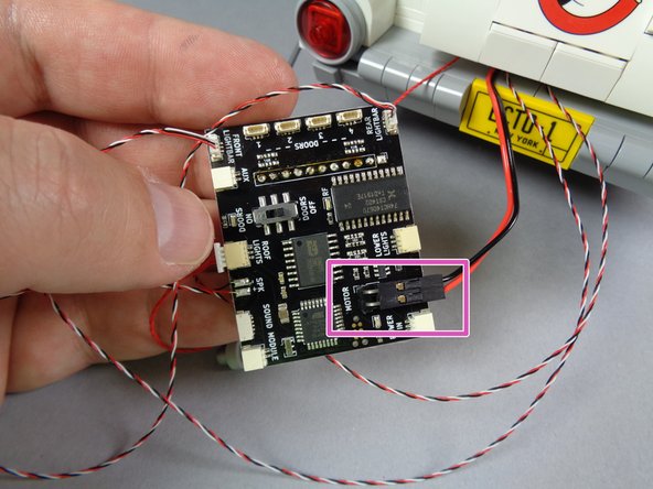 As shown by the pink rectangle in the second photo, next connect the roof motor plug to the main controller.