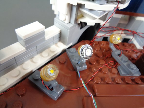 You should still have five color-changing spotlights in &quot;Color-Changing Spotlights&quot; bag.  Remove them and mount them along the inner castle wall next to the warm white spotlights you mounted earlier.