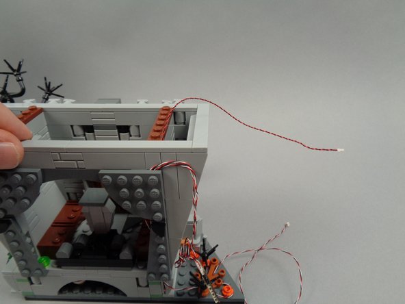 The second photo shows how the light wire should look after you've mounted the torch and run the wire out the top of the town hall.