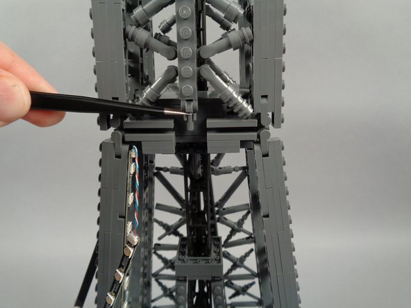 As shown in the photos for this step, next you will remove the top rear panel section above where you removed the lower rear section earlier.