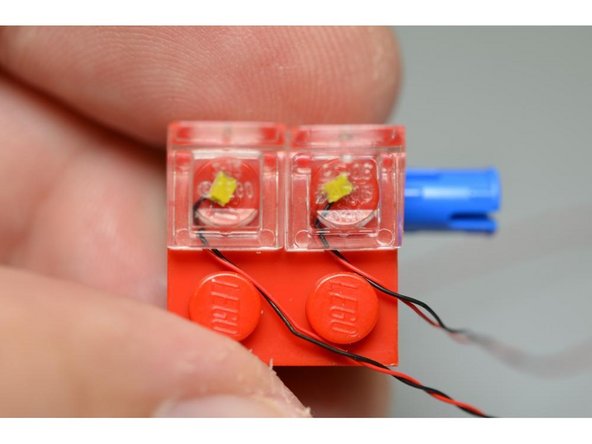 As long as you have prepared the LEDs as outlined in the previous step, snapping the slopes on top should not break the wires.  Try to snap the slopes on top of the LEDs only once-- removing and re-attaching the slopes increases the chances that the wire will be cut.