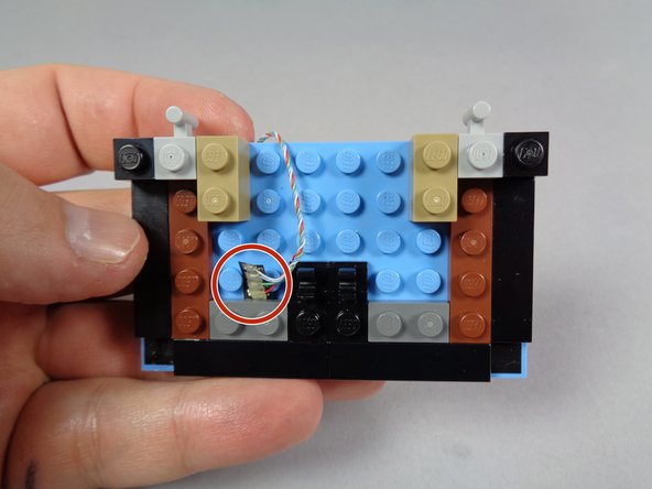 The red circle in the second photo shows the wires connecting to the pre-lit bottom marquee section.  Be very careful with these wires, and always make sure they do not run on top of any studs.  A damaged marquee lower section cannot be repaired.