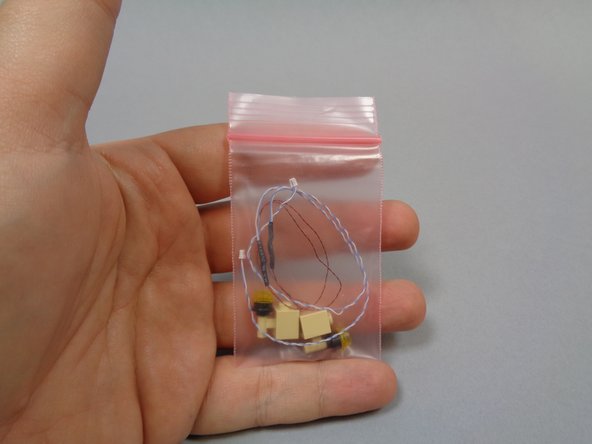 Inside Bag 8, there is a small bag with two wall torches inside.  Carefully remove the torches and un-tangle their wires if needed.