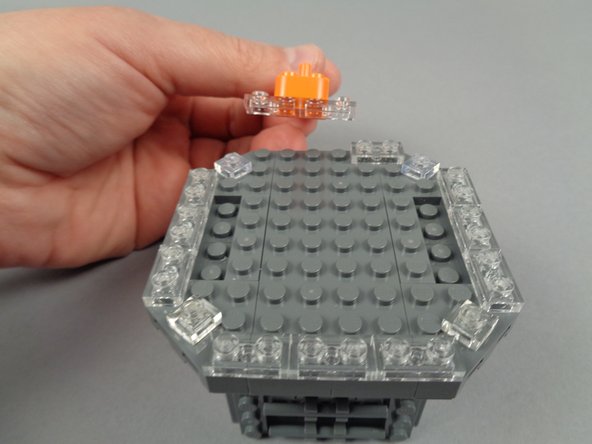 As shown in the photos for this step, remove the six clear 1x2 plates on either side of the top center.
