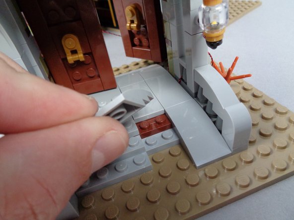 As shown in the second photo for this step, re-assemble the front wheelchair ramp.