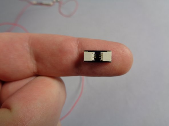 Also inside the Main Parts bag, there will be two adapters like the one shown in the first photo for this step.  These have two large plugs, one on either end, and are labeled BRANCH13 on the back.