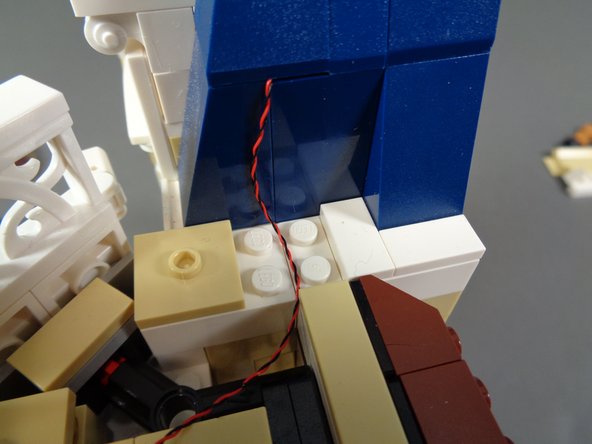 As shown by the green arrows in the first photo, make sure the light wire has enough slack to allow it to bend at the point where it meets the tan jumper plates.